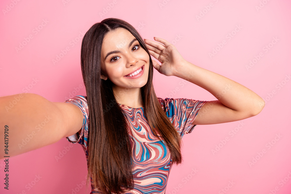 Photo of charming sweet girl wear print t-shirt recording vlog smiling empty space isolated pink color background