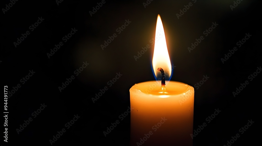 Close up single candle light and flame on black background Close up single candle light and flame on black background