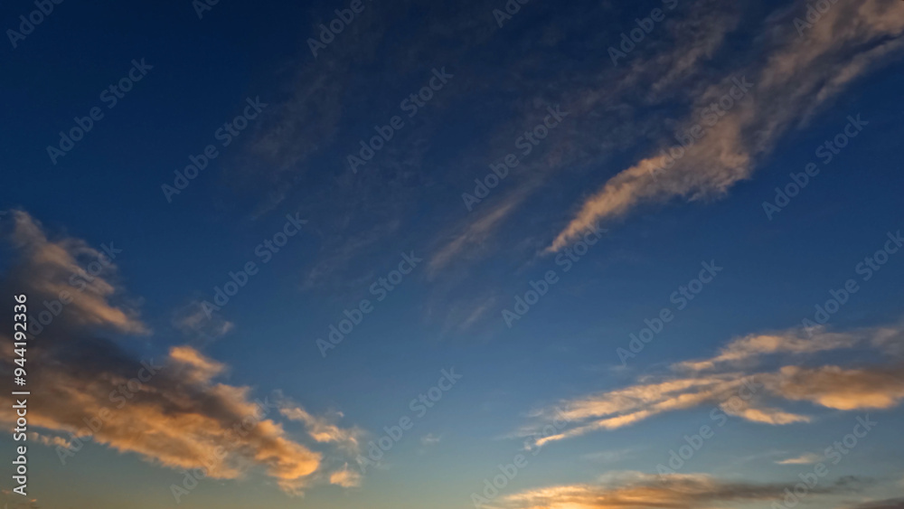 Fototapeta premium pretty sunset goldish clouds on the sky backdrop - photo of nature