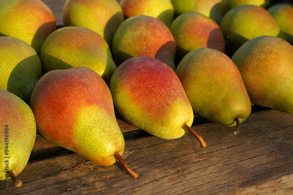 ripe juicy pears lie on an old wooden table. ripe juicy pears lie on an old wooden table.