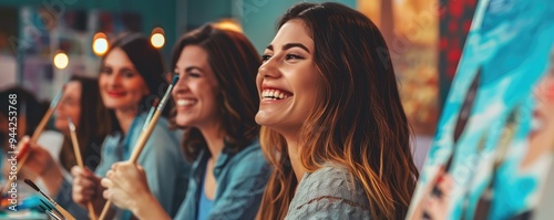Woman smiling at painting night with wine and friends
