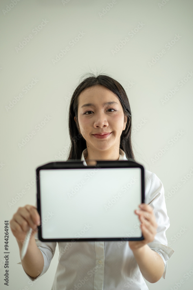 A woman is holding a tablet with a white screen A woman is holding a tablet with a white screen