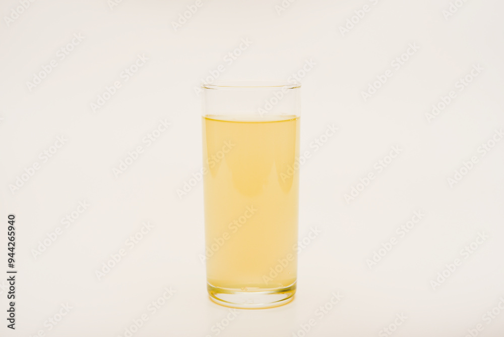 A glass glass with soda on a white background. Juice in a glass. A glass glass with soda on a white background. Juice in a glass.