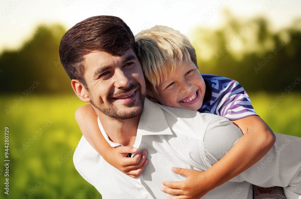 Happy father with small son on field at summer Happy father with small son on field at summer