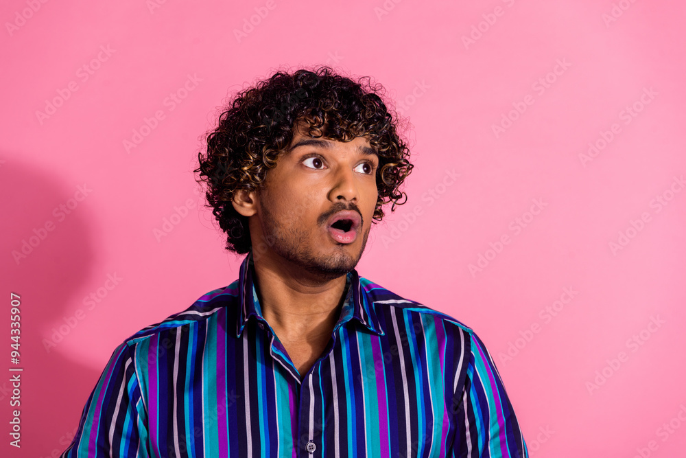 Photo of impressed funny man wear trendy striped clothes look empty space offer isolated on pink color background Photo of impressed funny man wear trendy striped clothes look empty space offer isolated on pink color background