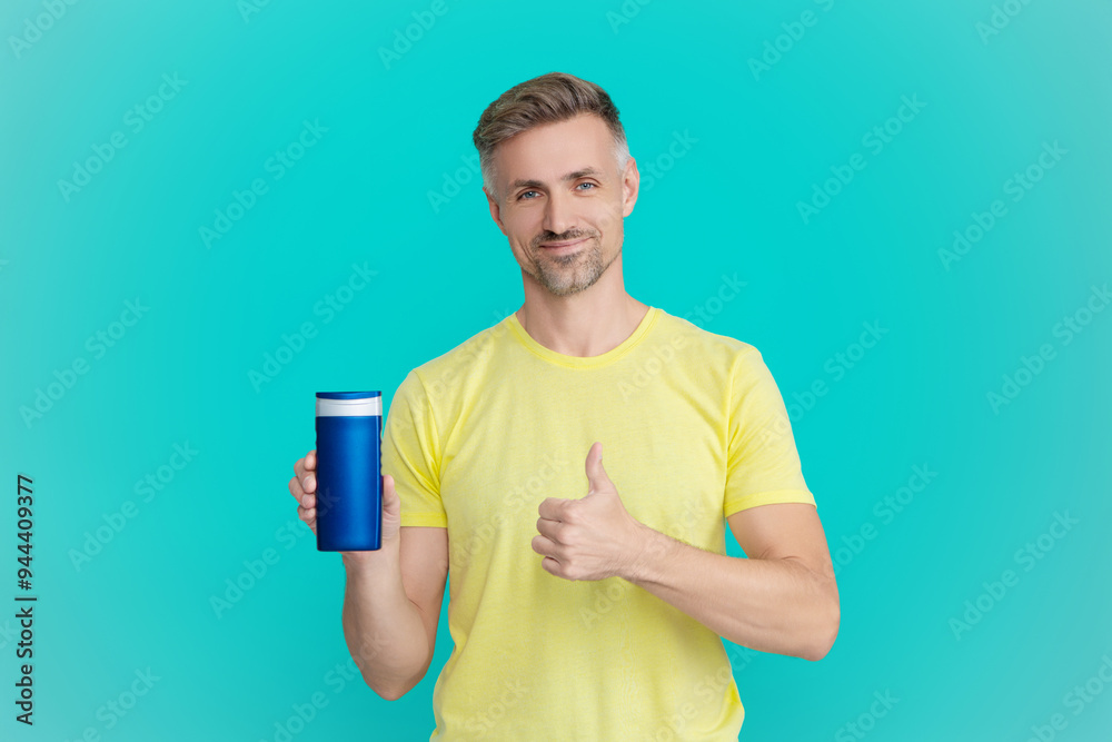 Man use shampoo. Mature man hold hair conditioner. Man with aftershave. Daily habit and personal care. Skincare beauty cosmetic. Shampoo or aftershave. Presenting male cosmetics product. Thumb up