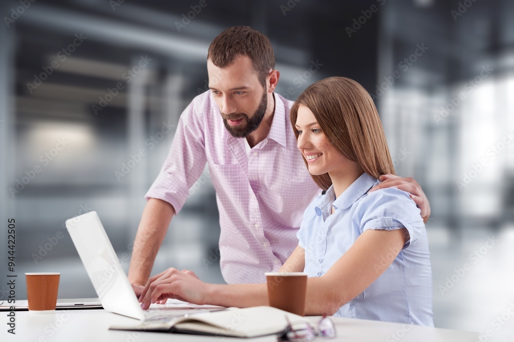 Two happy business people working in office. Two happy business people working in office.