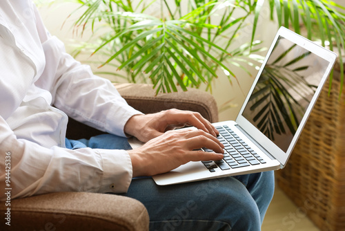 Woman typing on laptop whil...
