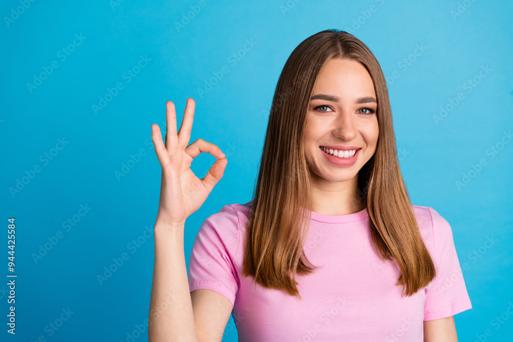 Photo of satisfied lovely cute woman wear trendy clothes okey sign isolated on blue color background Photo of satisfied lovely cute woman wear trendy clothes okey sign isolated on blue color background