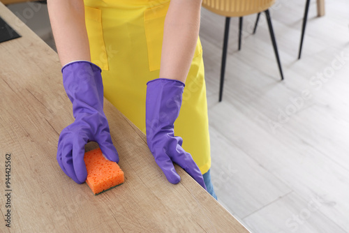 Person in purple gloves cle...