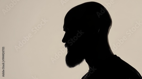 Thoughtful Silhouette of a Bald, Bearded Man: Around 30 Years Old, Set Against a Plain White Background with Ample Copy Space