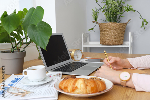 Woman working at table with...