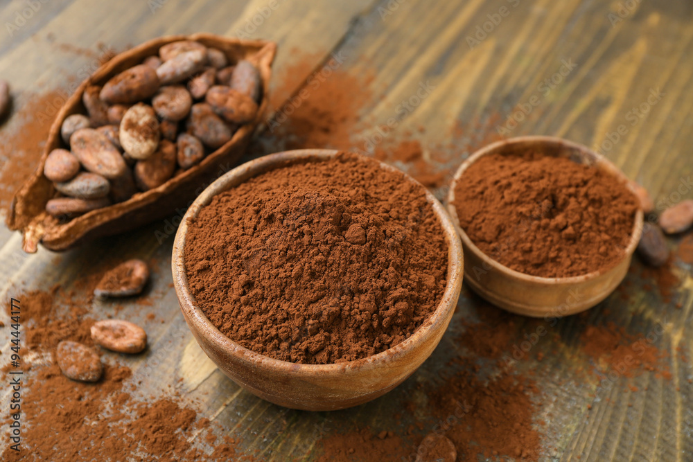 Bowls with cocoa powder on wooden background Bowls with cocoa powder on wooden background