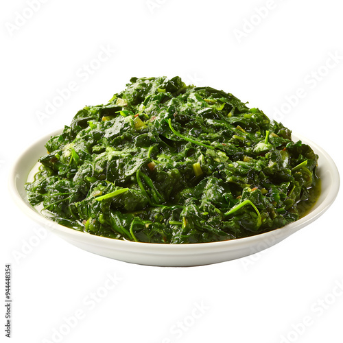 Newly prepared spinach placed in a clean white bowl, displayed against a clear backdrop, ideal for food styling and cooking projects photo