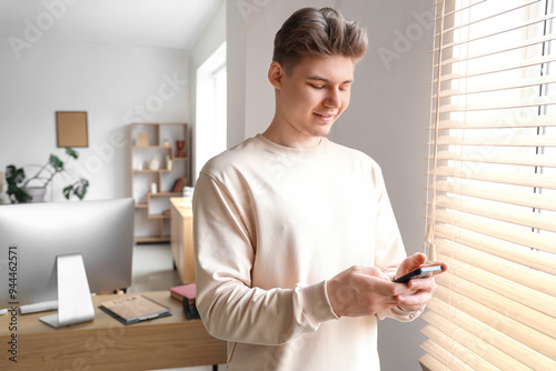 Young man using mobile phon...