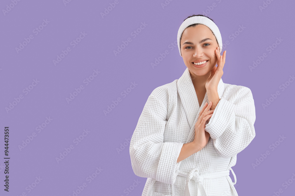 Beautiful young happy woman in bathrobe on purple background Beautiful young happy woman in bathrobe on purple background