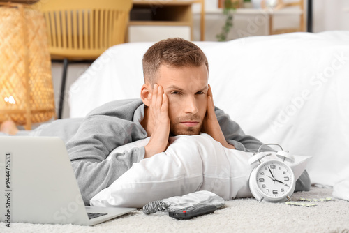 Young man with alarm clock,...