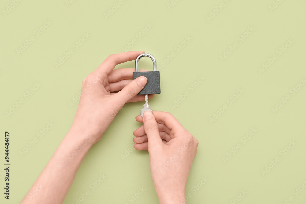 Hands with padlock and key on green background Hands with padlock and key on green background