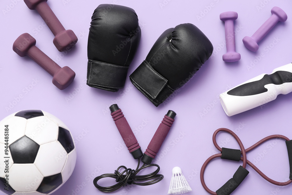 Set of sports equipment on lilac background, top view Set of sports equipment on lilac background, top view