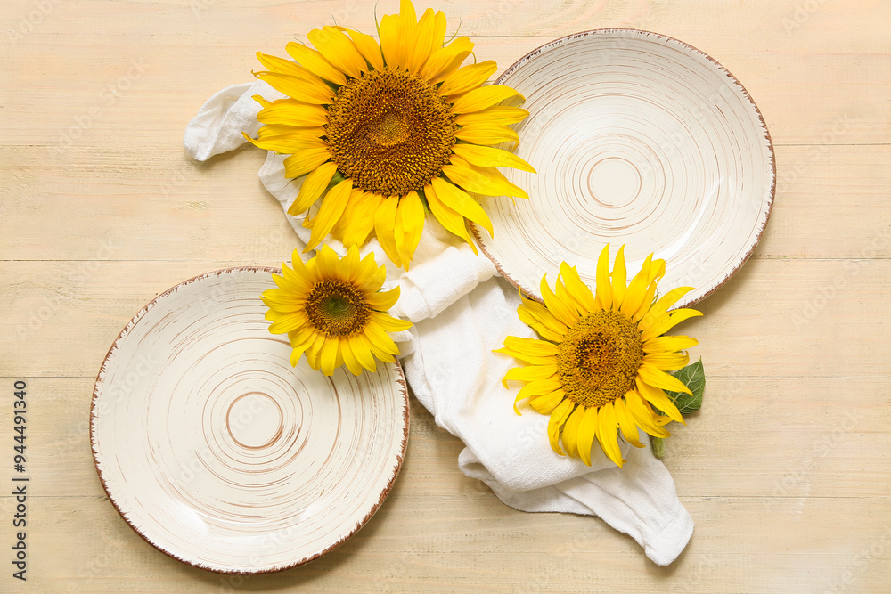 Beautiful table setting with sunflowers on beige wooden background Beautiful table setting with sunflowers on beige wooden background