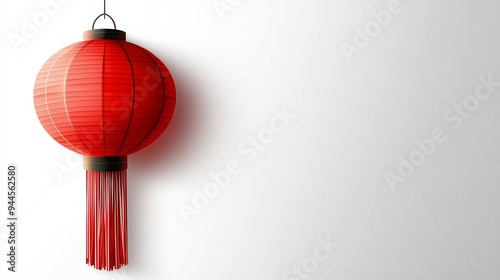 Red lantern with tassels hanging against a plain white background Created with Generative AI. photo