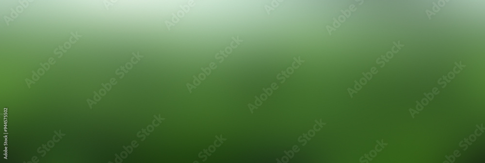 A blurred backdrop of vibrant green grass offers a serene atmosphere in a natural outdoor setting A blurred backdrop of vibrant green grass offers a serene atmosphere in a natural outdoor setting