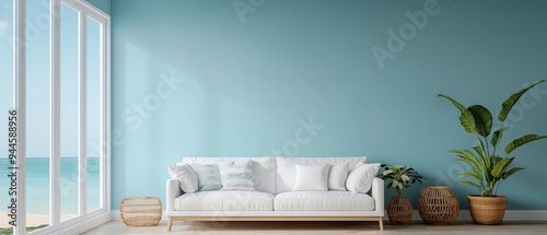 Bright and airy living room with a light sofa, plant, and coastal view creating a peaceful atmosphere.