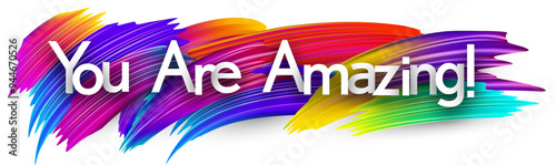 You are amazing paper word sign with colorful spectrum paint brush strokes over white. Vector illustration.