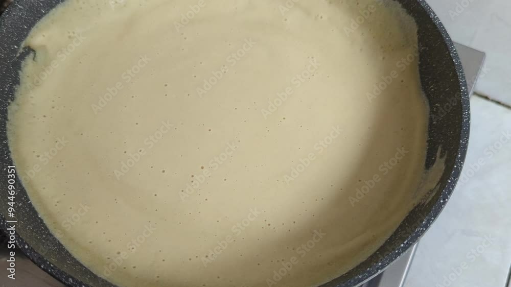 Close-up shot of frying pancakes on the hot pan. Making homemade crepes for family breakfast, Making Crepes on frying pan. Close-up shot of frying pancakes on the hot pan. Making homemade crepes for family breakfast, Making Crepes on frying pan.