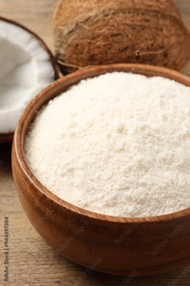 Coconut flour in bowl and fresh fruits on table, closeup Coconut flour in bowl and fresh fruits on table, closeup