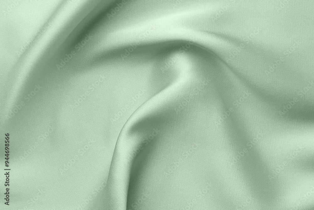 Fototapeta premium Crumpled sage color silk fabric as background, top view