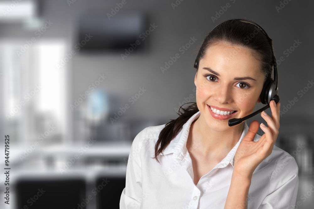 Smiling business person with headset working in a call center Smiling business person with headset working in a call center
