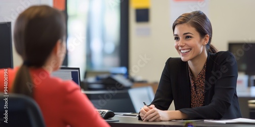 Professional customer service representative engaging in a positive client interaction with a friendly smile and attentive listening in a modern office environment