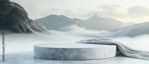 A serene landscape featuring a circular platform surrounded by misty mountains, perfect for showcasing products or artistic displays. photo