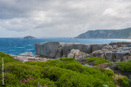 Rocky coastline at The Gap, Torndirrup National Park, near Albany, Western Australia. The image shows steep cliffs and rough ocean waters, typical of the rugged natural landscape of the area. photo