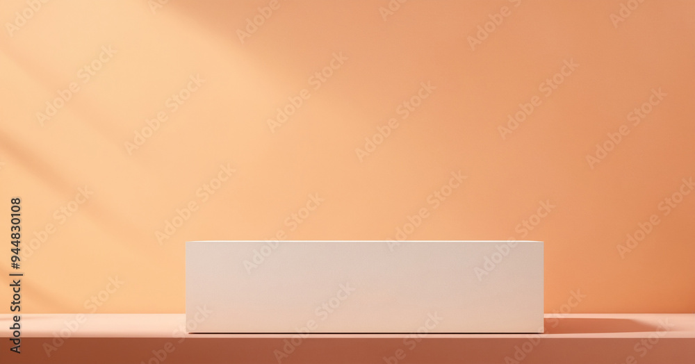 The minimalist white rectangular podium, exposed to soft natural light, creates a warm and calming atmosphere. The soft peach background gives an aesthetic and modern impression. The minimalist white rectangular podium, exposed to soft natural light, creates a warm and calming atmosphere. The soft peach background gives an aesthetic and modern impression.
