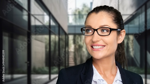 Happy and successful businesswoman posing in office.