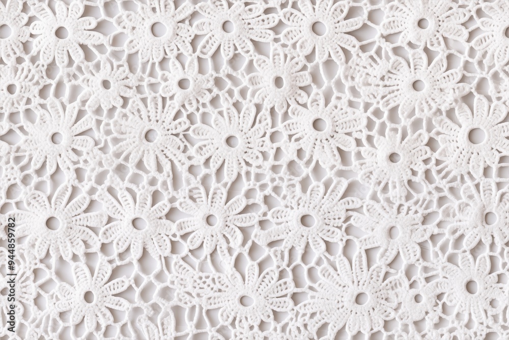 Cotton broderie anglaise texture. Intricate white lace fabric featuring floral patterns. The lace has a delicate design with various flower shapes and detailed cutouts.