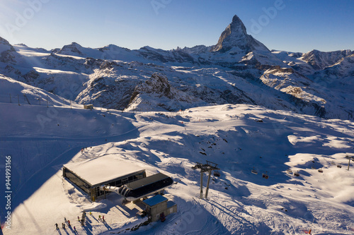 Zermatt, Switzerland: Dramatic view of the Zermatt ski resort slope and chairlift below the famous Matterhorn peak in winter in Canton Valais in the Swiss alps. photo