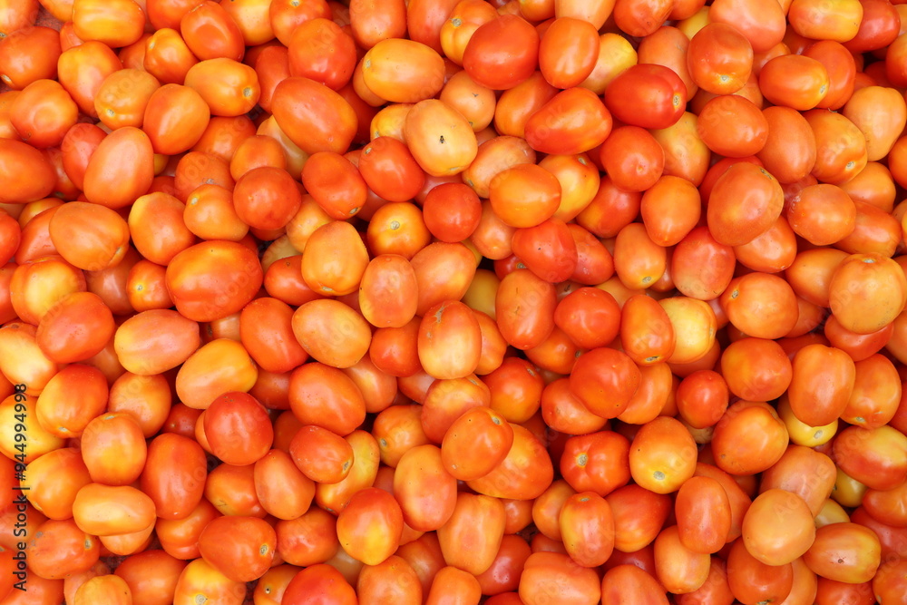 Heap of red ripe tomatoes in a vegetable whole sale market in India Heap of red ripe tomatoes in a vegetable whole sale market in India