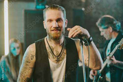 Valokuva Medium closeup portrait of young Caucasian rock vocalist with beard on face and