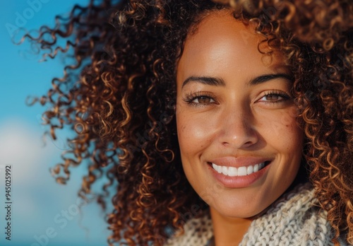 Radiant Curly-Haired Woman Smiling on a Sunny Day