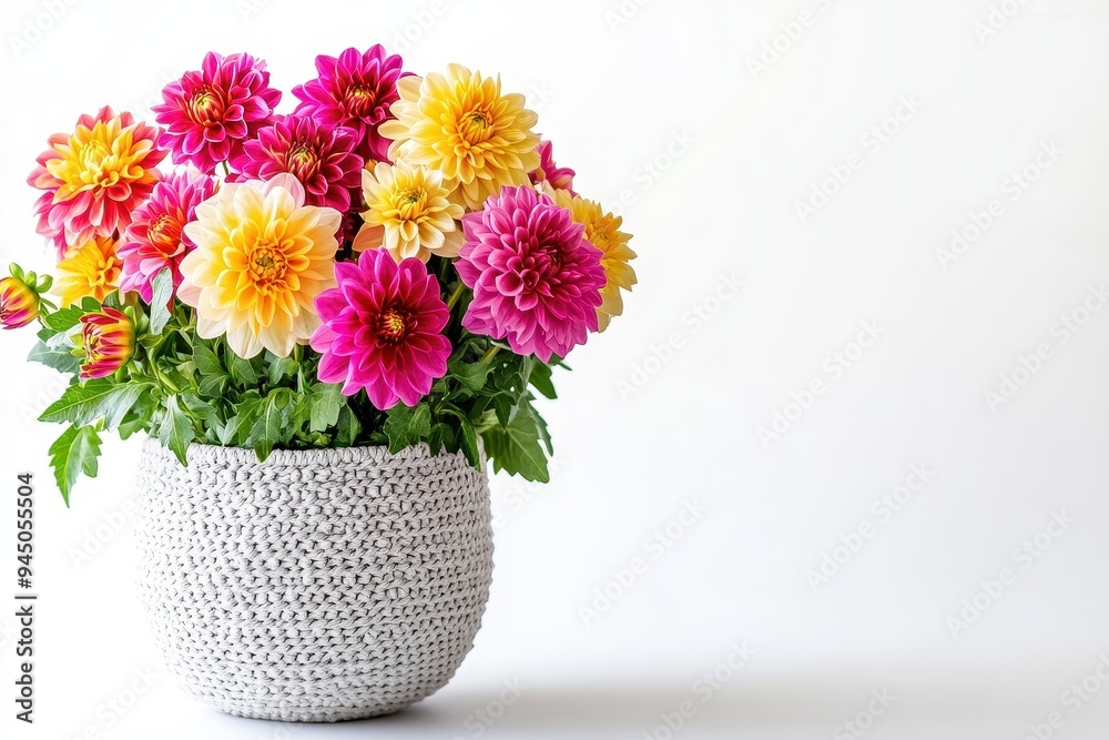 A vibrant bouquet of colorful flowers in a textured pot against a plain background. A vibrant bouquet of colorful flowers in a textured pot against a plain background.