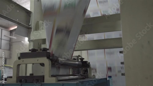 A busy book printing factory operates efficiently, with machines printing, binding, and packaging books through an automated process