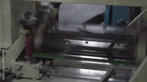 A busy book printing factory operates efficiently, with machines printing, binding, and packaging books through an automated process