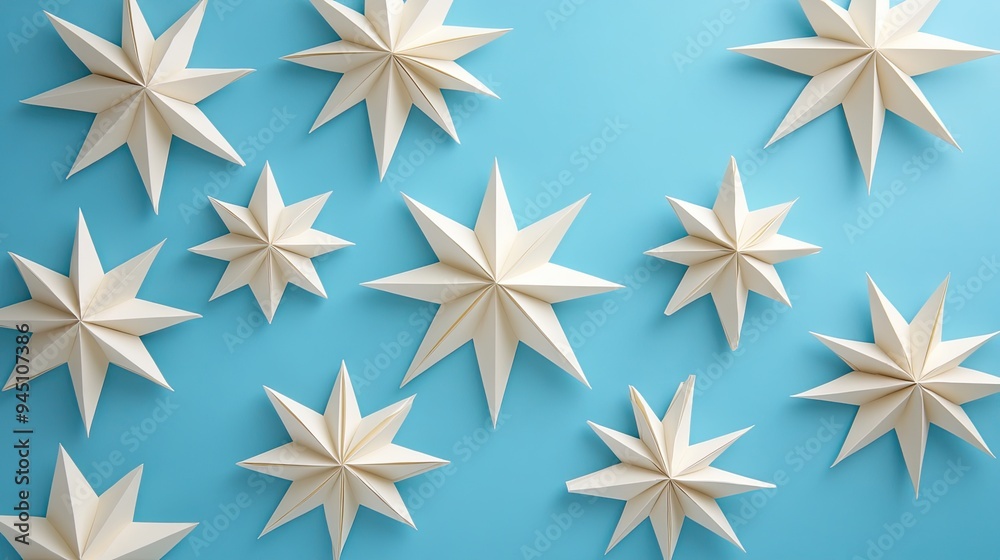 A vibrant collection of paper stars against a soft blue background, perfect for creative and festive design projects. A vibrant collection of paper stars against a soft blue background, perfect for creative and festive design projects.