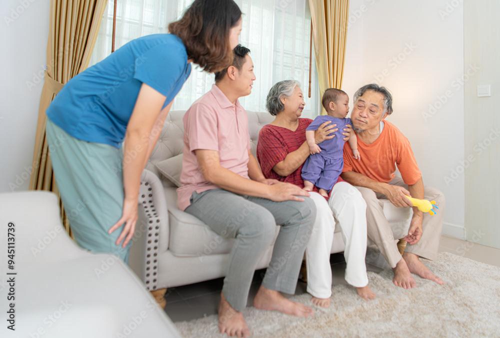 Grandparents and parents with their little child play happily in the living room of the house Grandparents and parents with their little child play happily in the living room of the house