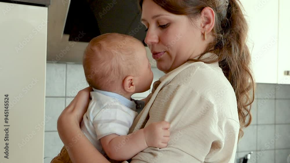 Young mum with newborn baby at home. Happy baby. Maternal care of newborn son. Baby. Mother embracing an infant Young mum with newborn baby at home. Happy baby. Maternal care of newborn son. Baby. Mother embracing an infant