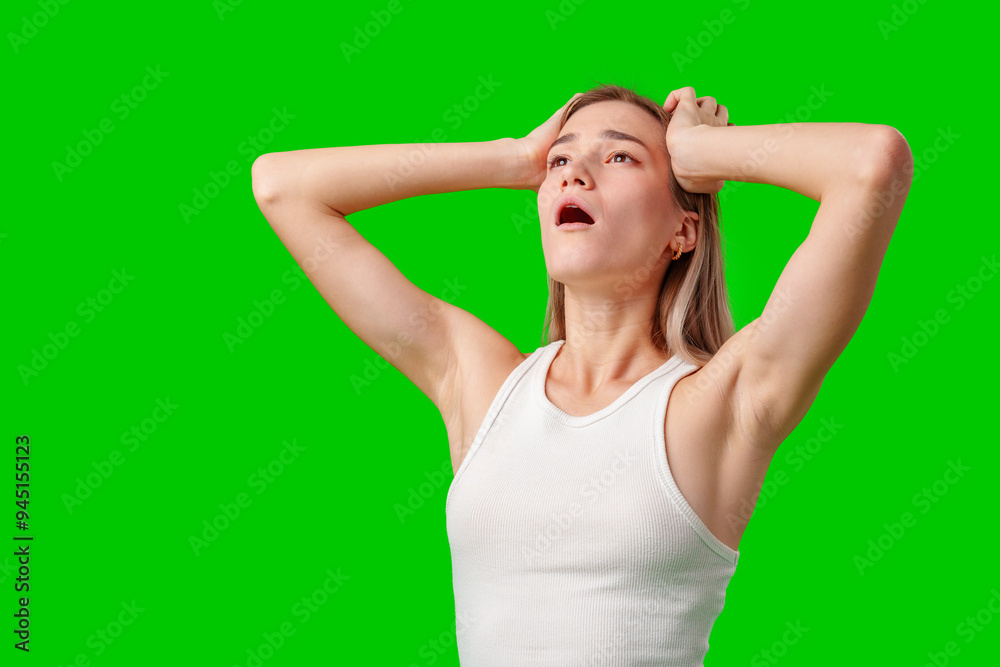 Young Woman Reacting in Surprise With Arms Raised Against a Green Screen