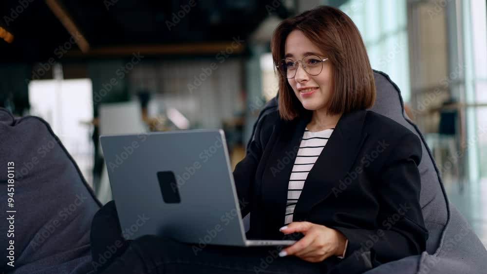 Freelancing lady working in the comfortable place on her laptop. Woman finishes her workday, closes laptop and leans in the chair relaxed. Freelancing lady working in the comfortable place on her laptop. Woman finishes her workday, closes laptop and leans in the chair relaxed.